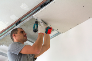 Professional drywall repair expert fixing wall cracks and holes to restore a smooth surface